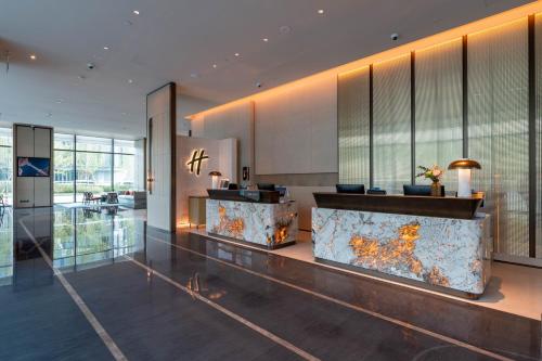 a lobby with a large aquarium in a building at Holiday Inn Changchun High Tech Zone by IHG in Changchun