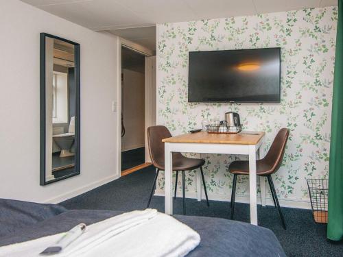 a hotel room with a table and two chairs at Romantic 2 person holiday home in Give in Give
