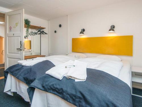 a bedroom with a large bed with white sheets at Romantic 2 person holiday home in Give in Give
