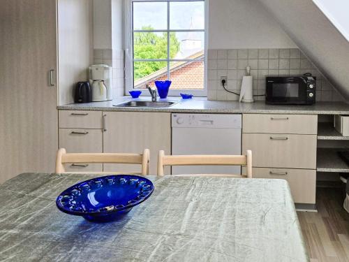a kitchen with a table with a blue bowl on it at 4 person holiday home in Ansager in Ansager