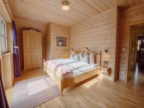 a bedroom with a bed in a wooden room at Chalet near Lake Grundlsee with Sauna in Grundlsee