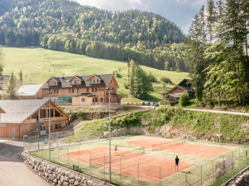 a tennis court in front of a house at Chalet near Lake Grundlsee with Sauna in Grundlsee
