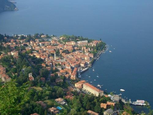 an island in the water with houses and buildings at La Piazzetta in Menaggio
