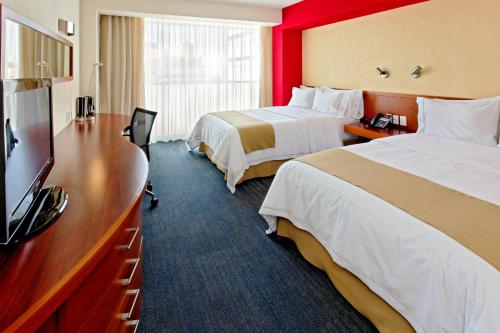 Ένα ή περισσότερα κρεβάτια σε δωμάτιο στο Holiday Inn Express Guadalajara Expo by IHG