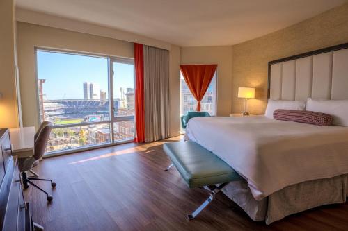 a hotel room with a large bed and a large window at Hotel Indigo San Diego - Gaslamp Quarter by IHG in San Diego