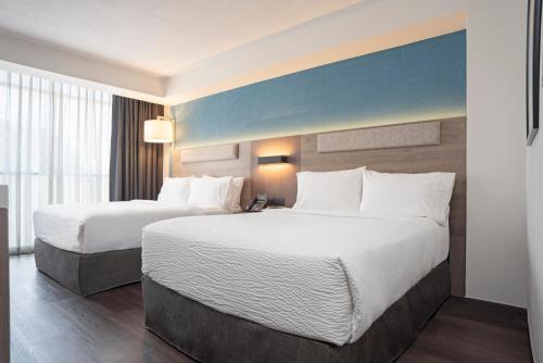 Ένα ή περισσότερα κρεβάτια σε δωμάτιο στο Holiday Inn Express Guadalajara Expo by IHG