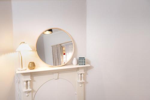 a mirror on top of a white table in a room at Bendigo Signature Accommodation on Barnard in Bendigo