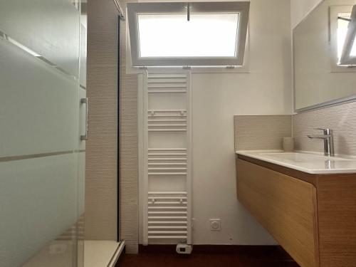 une salle de bain avec un lavabo et une fenêtre dans l'établissement Villa rénovée 4 pièces 80m² avec patio privé et accès plage - La Palmyre - FR-1-705-71, aux Mathes