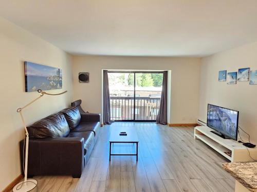 a living room with a couch and a tv at 1BDR Condo in the Heart of Olympic Valley! in Tahoe City
