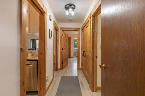 a hallway with wooden doors and a rug on the floor at 1BDR Condo in the Heart of Olympic Valley! in Tahoe City