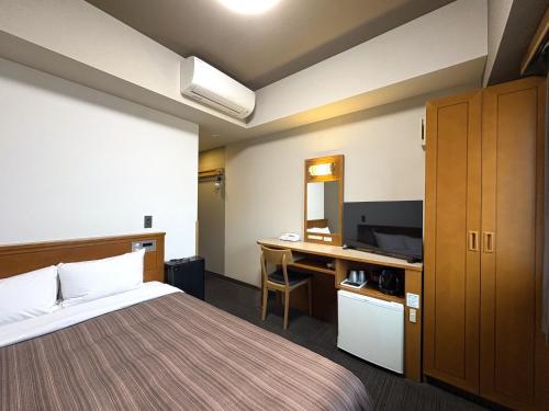 Postel nebo postele na pokoji v ubytování Hotel Route-Inn Honjo Ekiminami
