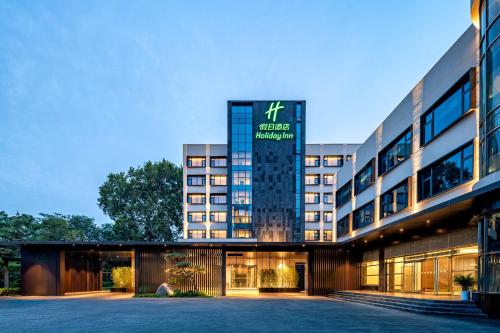 an exterior view of a hotel with a building at Holiday Inn Zhengzhou Zhongzhou by IHG in Zhengzhou
