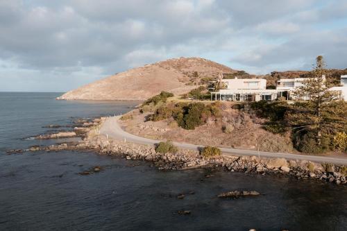 a house on a hill next to the ocean at Whalers Rest Ocean front Whale watching in Encounter Bay