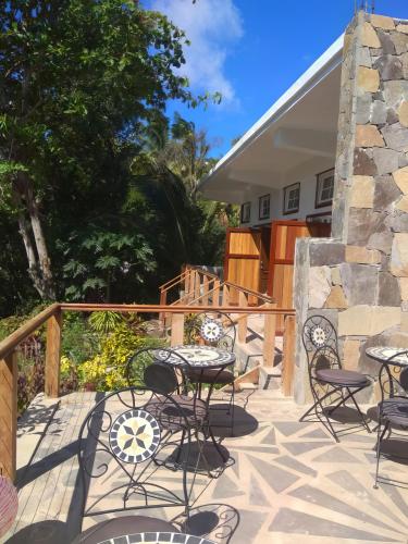 a patio with tables and chairs on a deck at Les Antigones in Crève Coeur