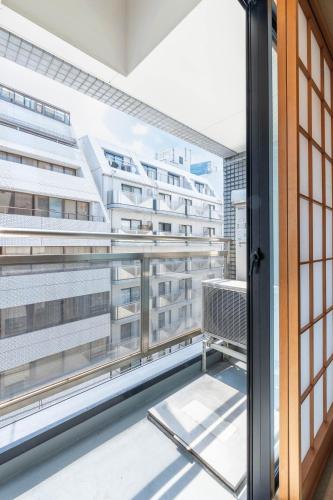 a balcony with a view of a building at Nihonbashi Kakigara Ryokan in Tokyo