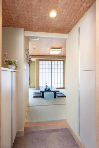 an empty room with a table in a room at Nihonbashi Kakigara Ryokan in Tokyo