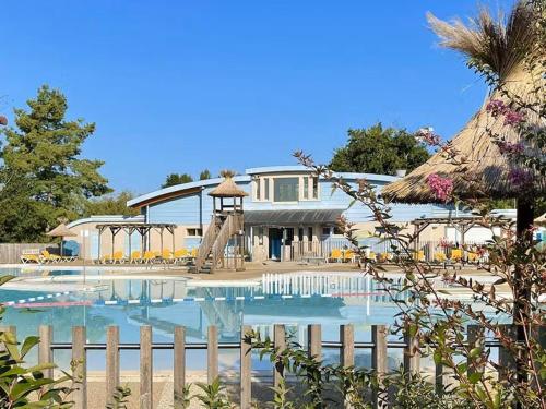 a swimming pool with a slide in front of a house at Studio lumineux avec balcon exposé sud pour 2 personnes - FR-1-841-46 in Barbotan-les-Thermes
