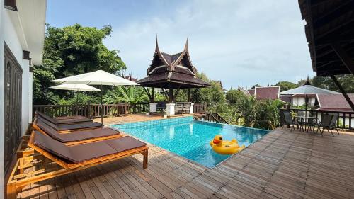 a swimming pool with a rubber duck in the middle at CM14 Beds & Private Pool in Mae Pim