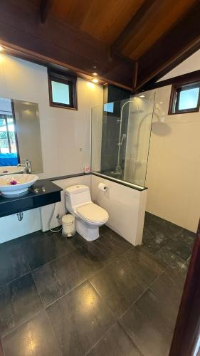 a bathroom with a toilet and a sink at CM14 Beds & Private Pool in Mae Pim