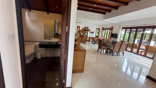 a bathroom with a sink and a toilet in a room at CM14 Beds & Private Pool in Mae Pim