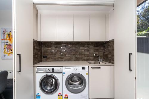 a kitchen with a washing machine and a sink at 3BR Home near Canberra Hospital and Parliament - Hosted by CanStay in Harman