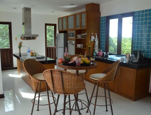 a kitchen with a table and chairs in a kitchen at CM14 Beds & Private Pool in Mae Pim