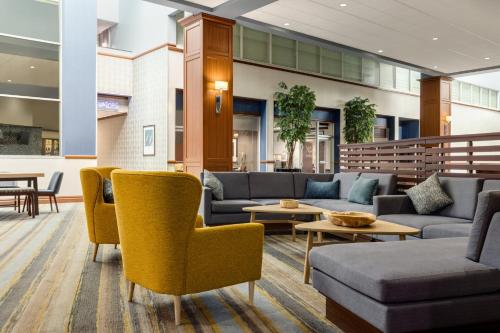 a lobby with couches and chairs and tables at Holiday Inn Louisville East - Hurstbourne by IHG in Louisville