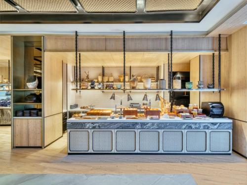 a large kitchen with a counter in a room at InterContinental Chiang Mai The Mae Ping in Chiang Mai