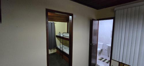 a bathroom with a sink and a toilet and a mirror at Pousada Casa Del Mare in São Pedro da Aldeia