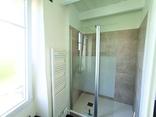 a shower with a glass door in a bathroom at Maison de charme au centre d'Étel - Idéale pour famille - FR-1-479-234 