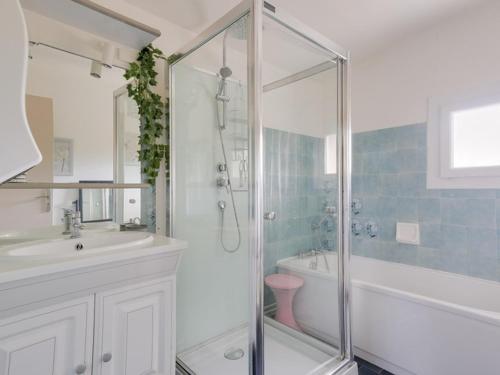 a bathroom with a shower and a tub and a sink at Villa rénovée T3 près du lac et thermes - FR-1-841-60 in Cazaubon