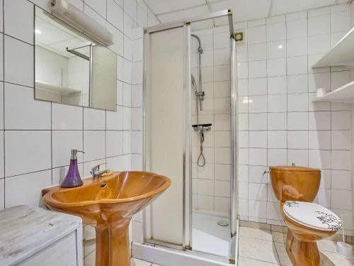 a bathroom with a wooden sink and a toilet at Charmant T2 avec terrasse fleurie, WiFi, animaux admis - FR-1-841-81 in Barbotan-les-Thermes