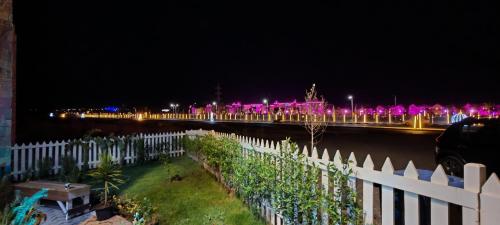 a bridge with pink lights in the distance at night at فيلا بجوار سينزو مول in Hurghada