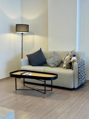 a living room with a couch and a coffee table at Poolside Paradise, Nice pool view in Kathu