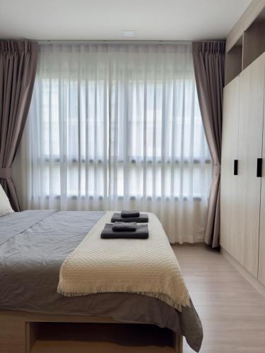 a bedroom with a bed and a large window at Poolside Paradise, Nice pool view in Kathu