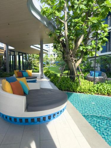 a couch sitting next to a swimming pool at Poolside Paradise, Nice pool view in Kathu
