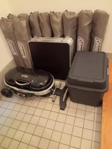 a suitcase sitting on the floor next to aasy at Lake England 富士山が見える隠れ家ロッジ in Fujikawaguchiko