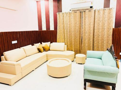 a living room with a couch and two chairs at Mango People Farm in Gurgaon