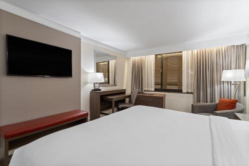 a hotel room with a bed and a television at Crowne Plaza Executive Center Baton Rouge by IHG in Baton Rouge