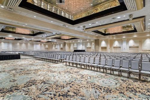 an empty auditorium with rows of chairs in a building at Crowne Plaza Executive Center Baton Rouge by IHG in Baton Rouge