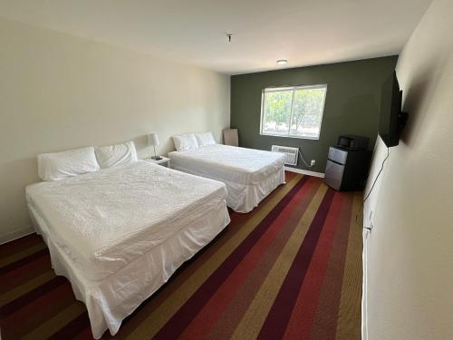 a hotel room with two beds and a window at The Ridge Hotel - Manitou Springs in Manitou Springs