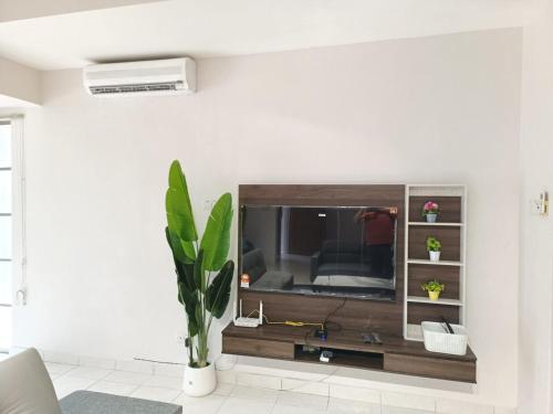 a living room with a flat screen tv on a wall at Semi D 1-13 pax Klang Botanic Lengkuk Rhu 5R4B YSW Homes in Klang