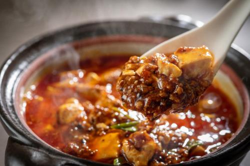a spoonful of food in a bowl of food at Art Hotel Narita in Narita