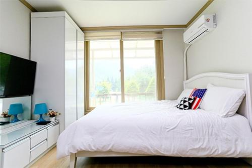En eller flere senge i et værelse på Hongcheon The Pyeonhan Pension