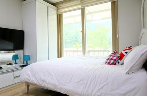 En eller flere senge i et værelse på Hongcheon The Pyeonhan Pension