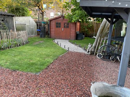 a backyard with a yard with a shed at Tiny House Le Poulailler in Bousbecque