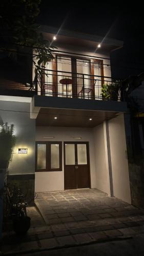 a large house with a balcony and a door at Private 2BR Townhouse at Malioboro in Yogyakarta