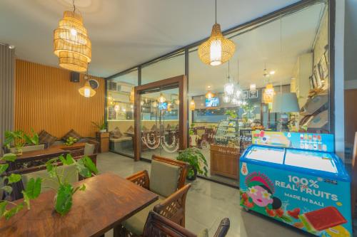 a restaurant with a table and a pizza box at Nirmala Hotel Jimbaran in Jimbaran