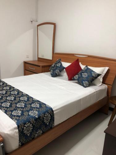 a bedroom with a bed with a mirror on it at Summer Villa in Badulla