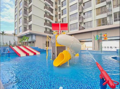 a swimming pool with a water slide in a building at Bali Residence Malacca - n stays in Melaka